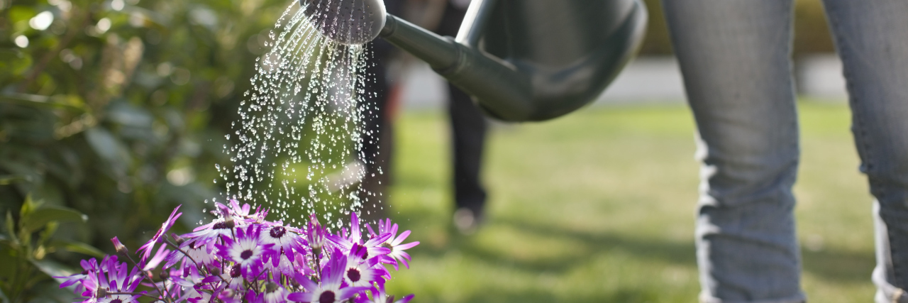Woman watering flowers