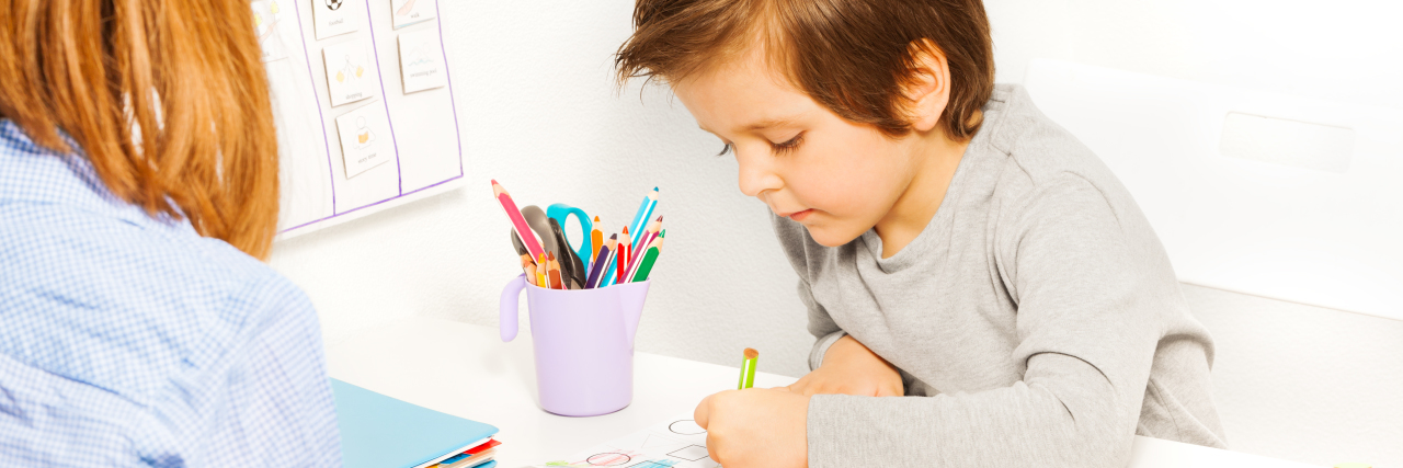 8 Steps to Take If Your Child Shows Signs of a Developmental Delay Boy working with early intervention therapist.