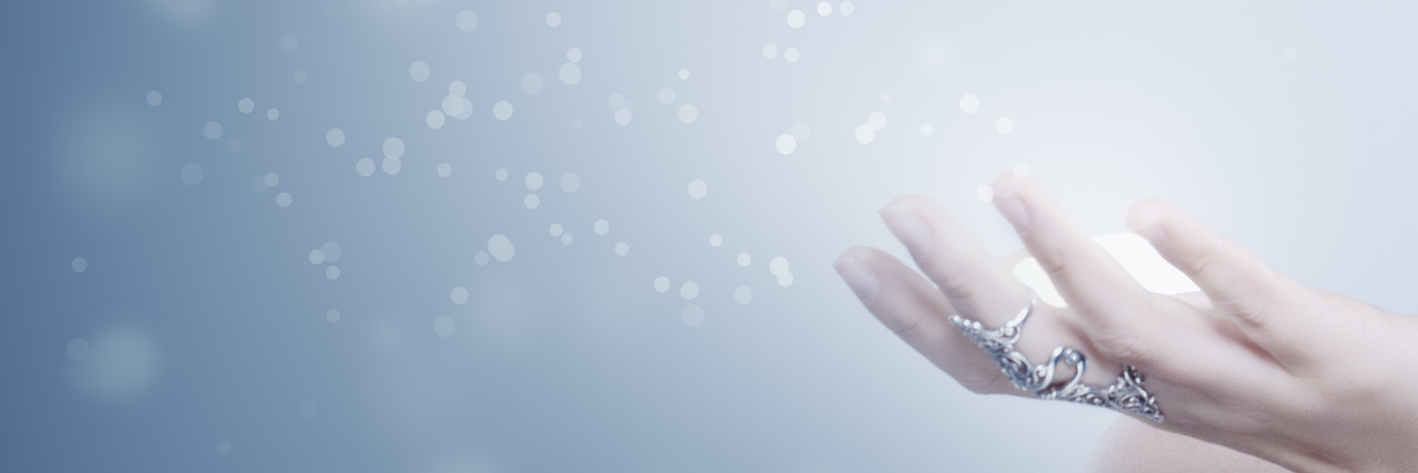 Snowflakes emitting from woman's hand.