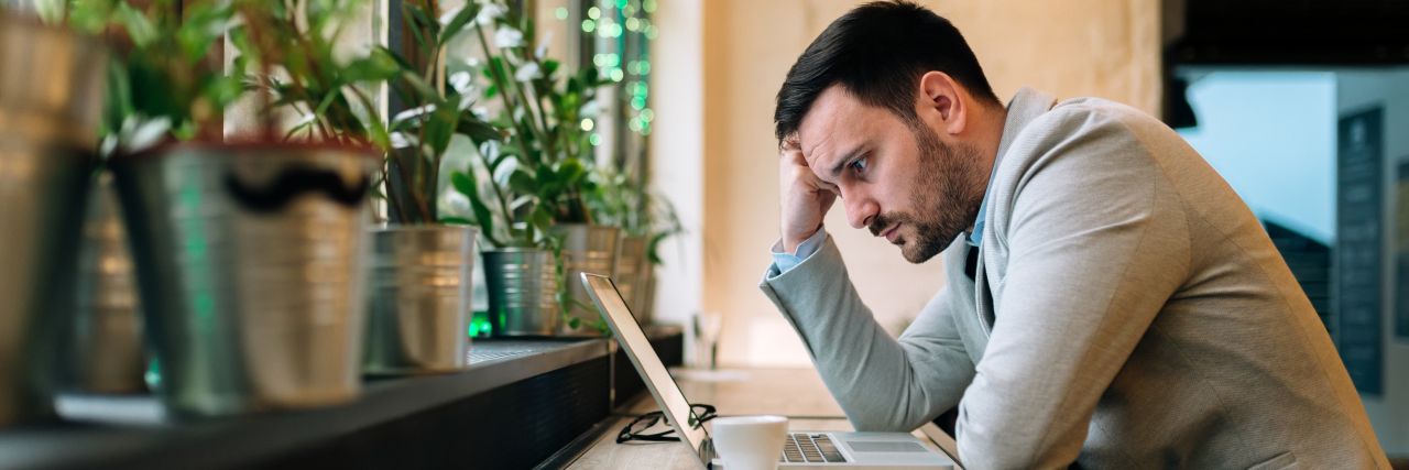 Why Disability Support Is Important When You Have Schizophrenia a man at a cafe staring at his computer