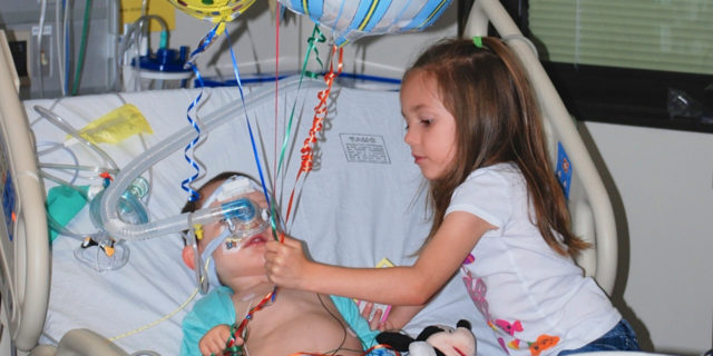 Lori's daughter helping her son in the hospital.