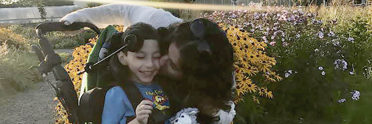 A Day in the Life -- Parenting My Son With Disabilities Jaclyn with her son outdoors.