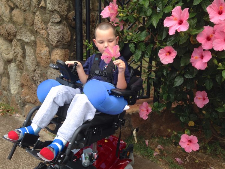 Lori's son smelling the roses.