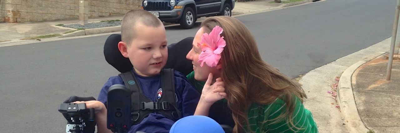 How Rare Disease Day Helps to Destigmatize Disability Lori with her son outside.