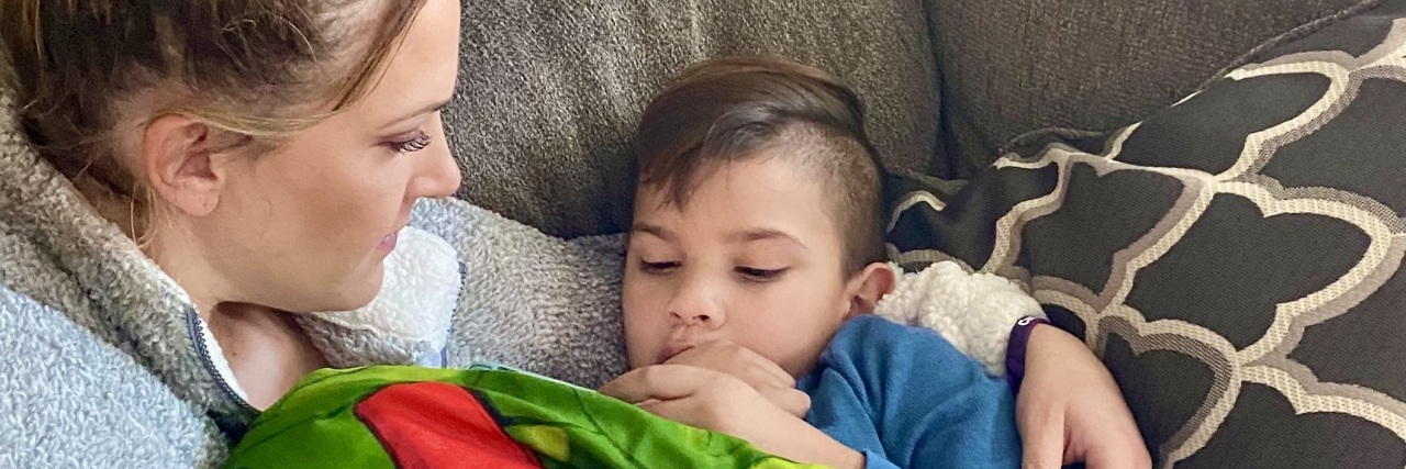 How Do You Cope With Knowing Your Child Has a Terminal Disease? Jen holding her son on the sofa