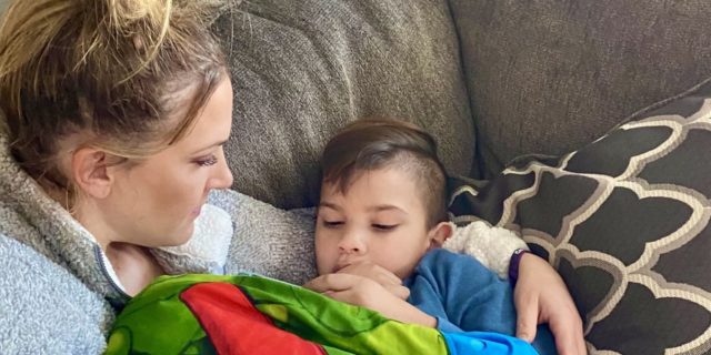 How Do You Cope With Knowing Your Child Has a Terminal Disease? Jen holding her son on the sofa