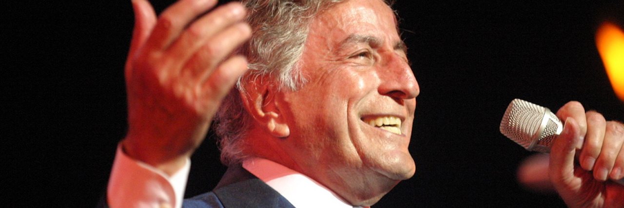 Tony Bennett sings into a microphone