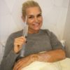 Yolanda Hadid lying in a hospital bed, smiling