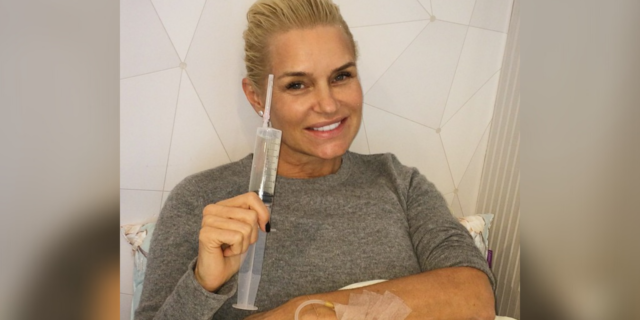 Yolanda Hadid lying in a hospital bed, smiling