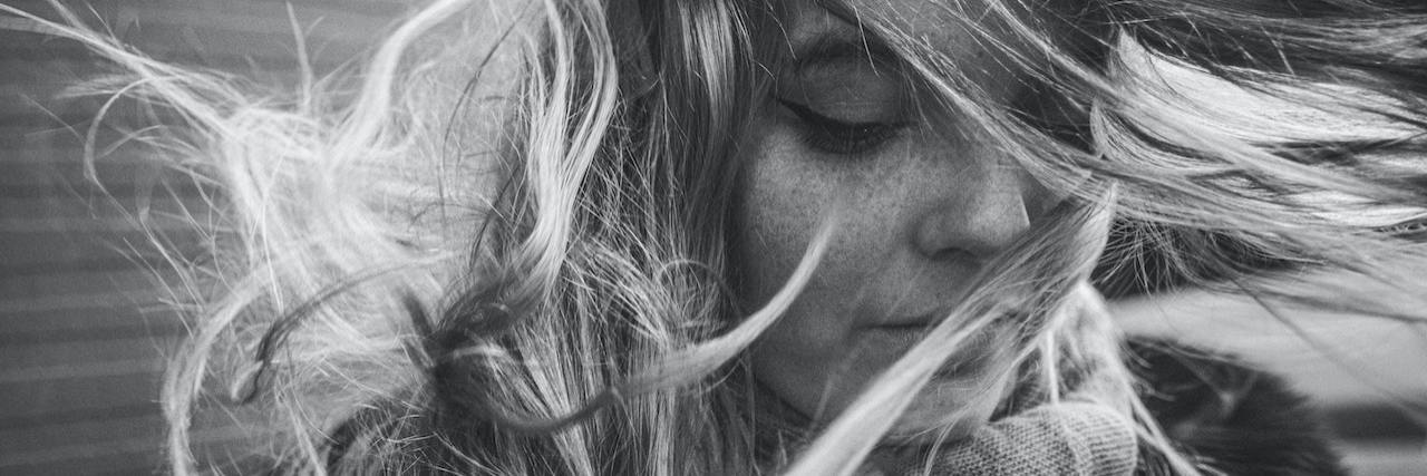 Getting Through the Day With Anxiety and Depression Black and white portrait of a woman with hair in her face