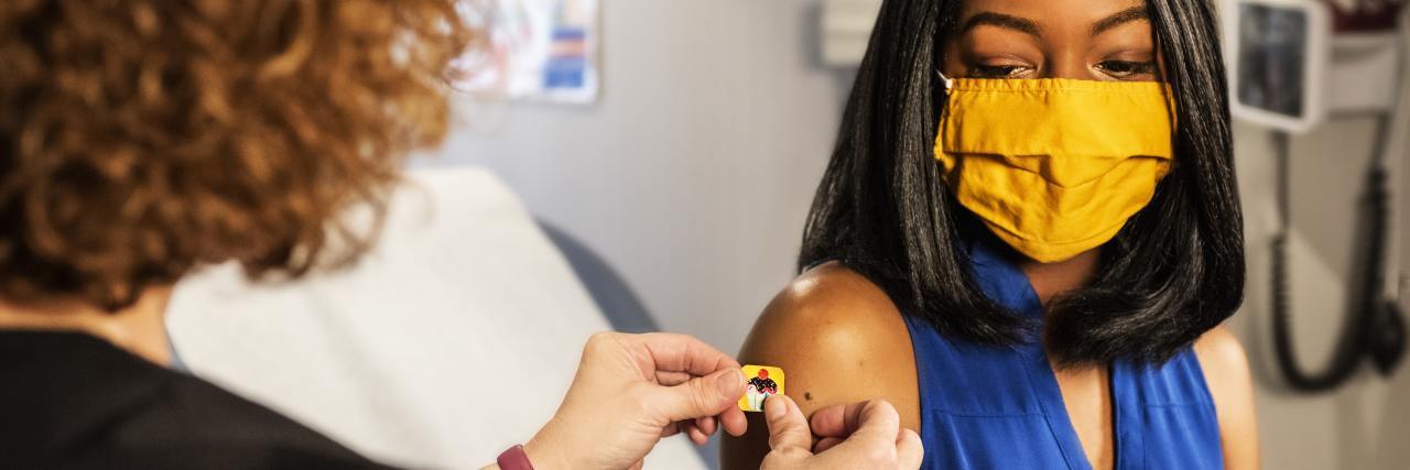 It's OK if You're Scared and Anxious About the COVID-19 Vaccine photo of a woman receiving a vaccine from a nurse