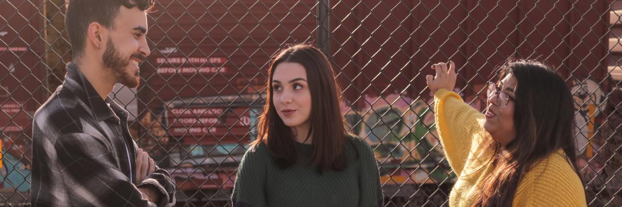 Mental Health America: Survey Shows Need to Listen to Young People photo of three teens talking by chainlink fence