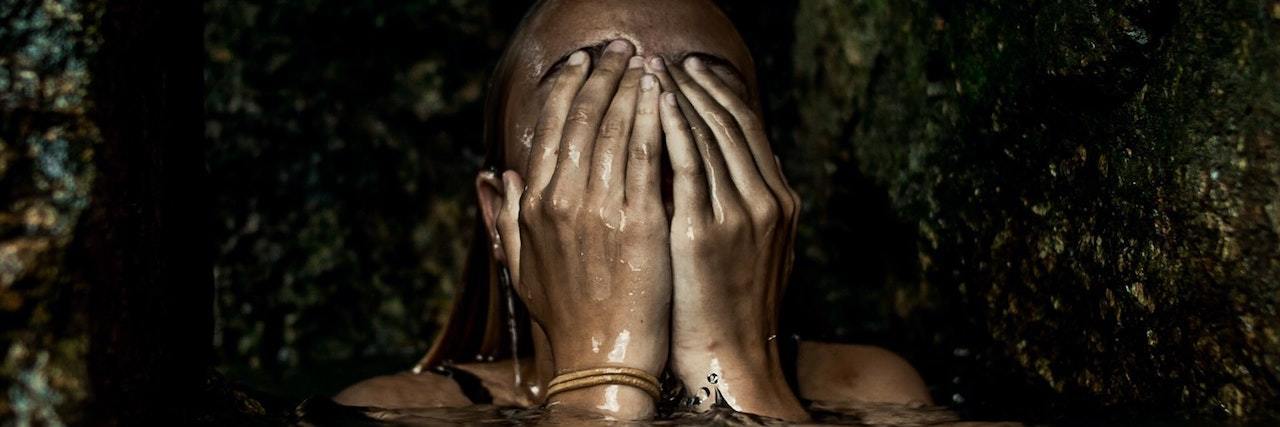Freeing Myself From Shame After My Mom Died by Suicide Woman in water, overing her hands over her face