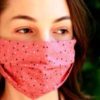 photo of young woman wearing a pink face mask with dotted design