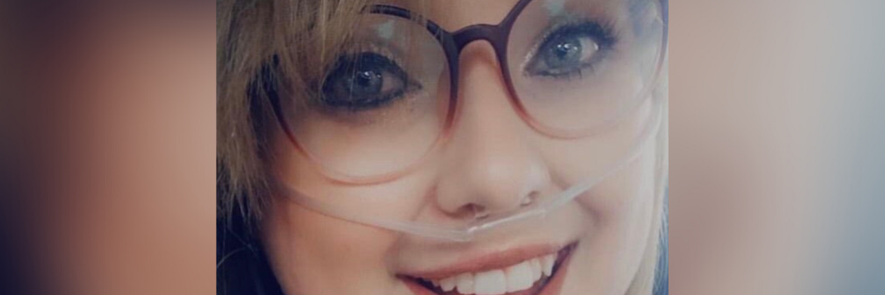 Photo of contributor wearing glasses, oxygen cannula and smiling