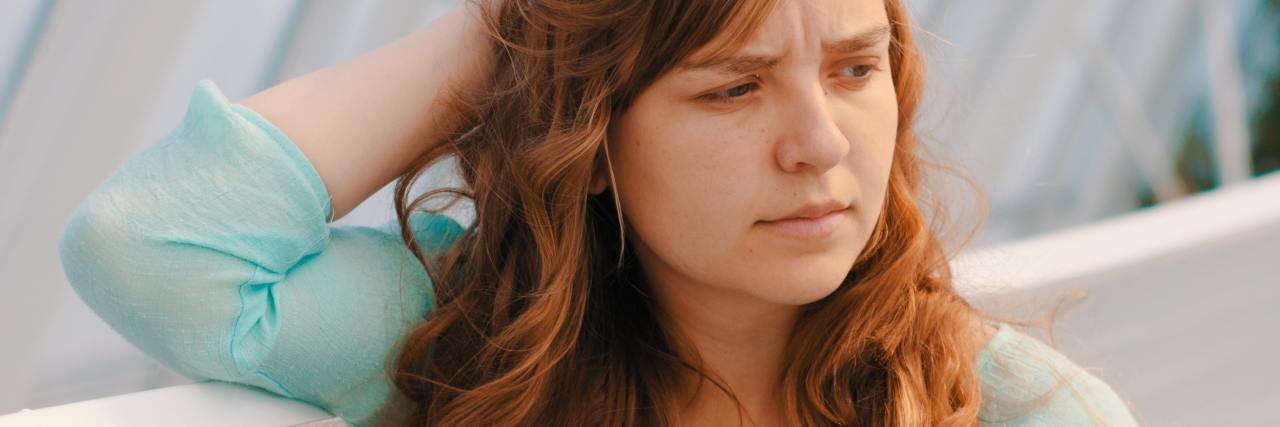 My 'Pet Peeves' About Living With Bipolar Disorder photo of woman looking off-camera with hand raised to her head, looking confused or annoyed