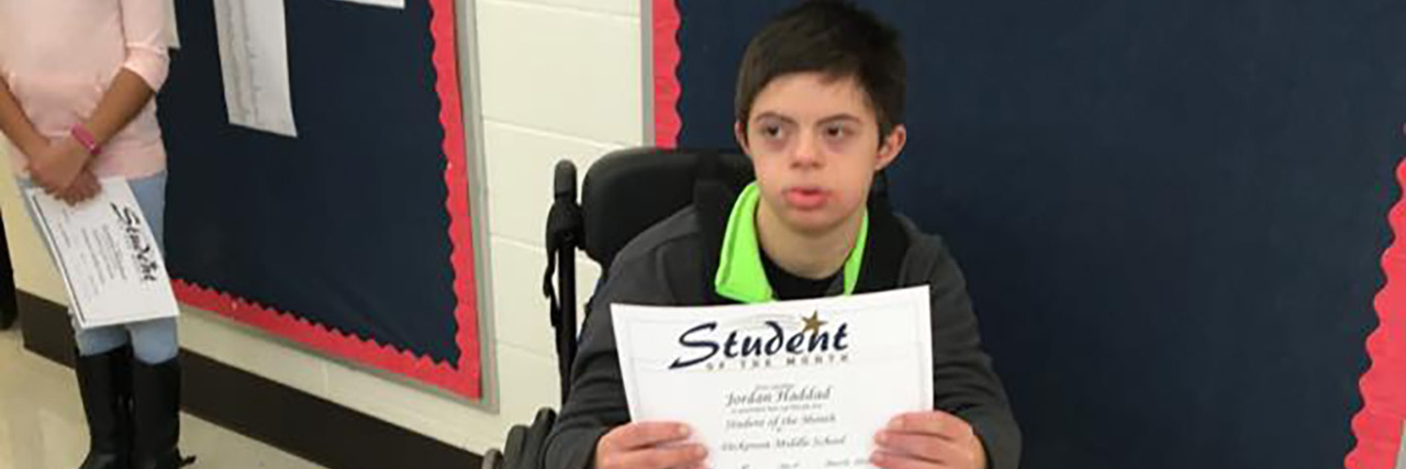 Our Son’s Journey With Down Syndrome and Lennox-Gastaut Syndrome Jordan holding a school award.