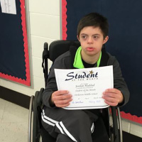 Jordan holding a school award.