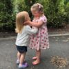 Toddler sisters embracing.