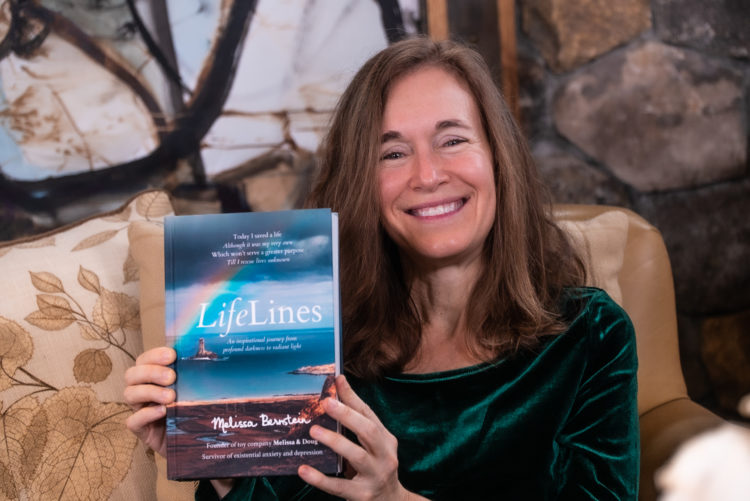 Melissa Bernstein holding her book "Lifelines"