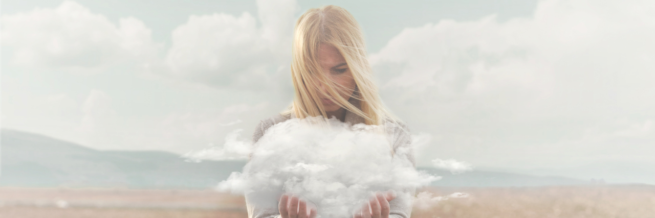 Brain Fog and Migraine -- What Is It Like? Woman holding a cloud in her hands