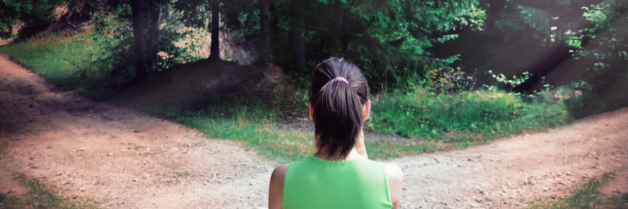 Choosing to Be Honest About How Lupus Has Affected My Life Woman standing at a fork in the road.