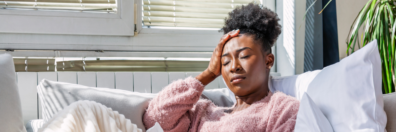KHN: Tuskegee Is Not an ‘Excuse’ for Current Medical Racism A black woman lying down with her hand on her head