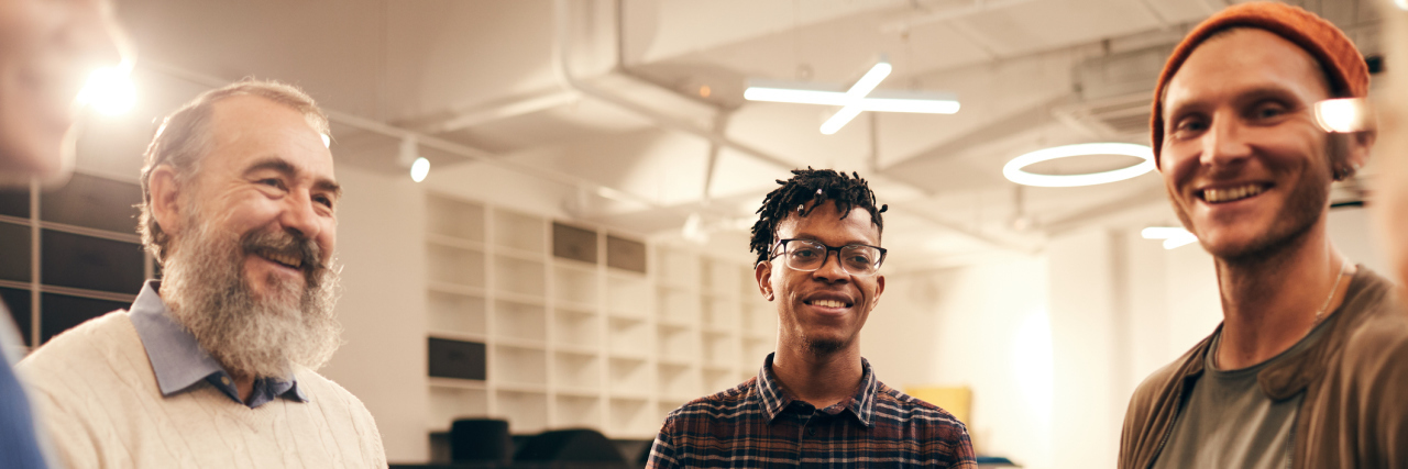 3 Types of Patients in a Psych Ward Who Helped My Recovery An older white man, a young black man, and a young white man holding hands and smiling at the camera
