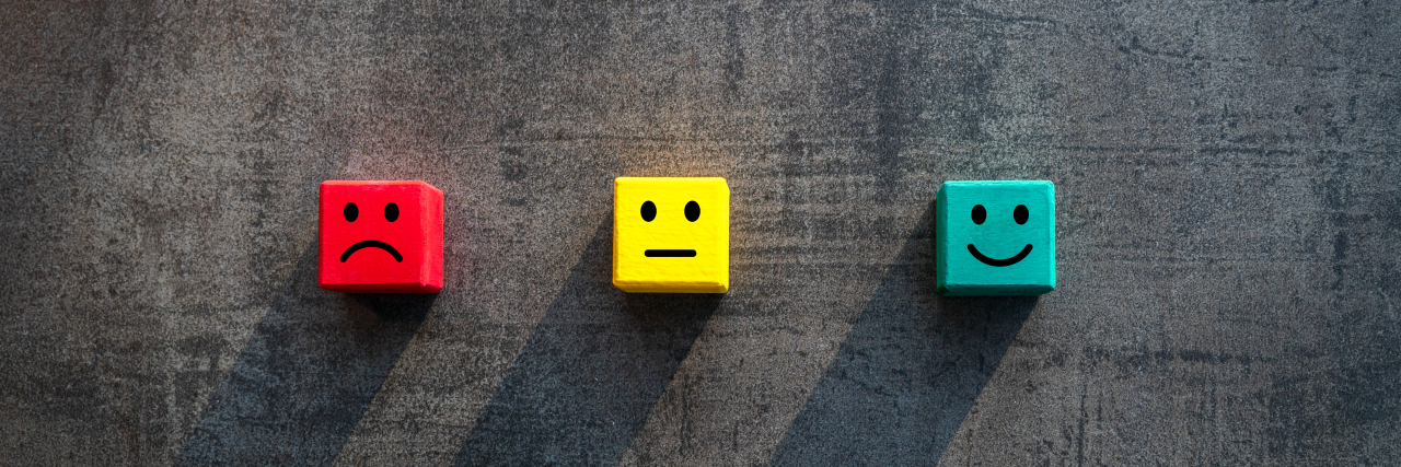 colorful small blocks with sad and happy faces