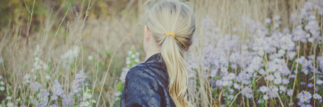 back view of a girl picking flowers