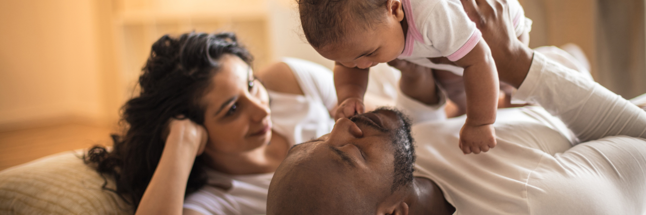 How to Help Your Child With Cerebral Palsy, From an Adult With CP African-American parents with baby.