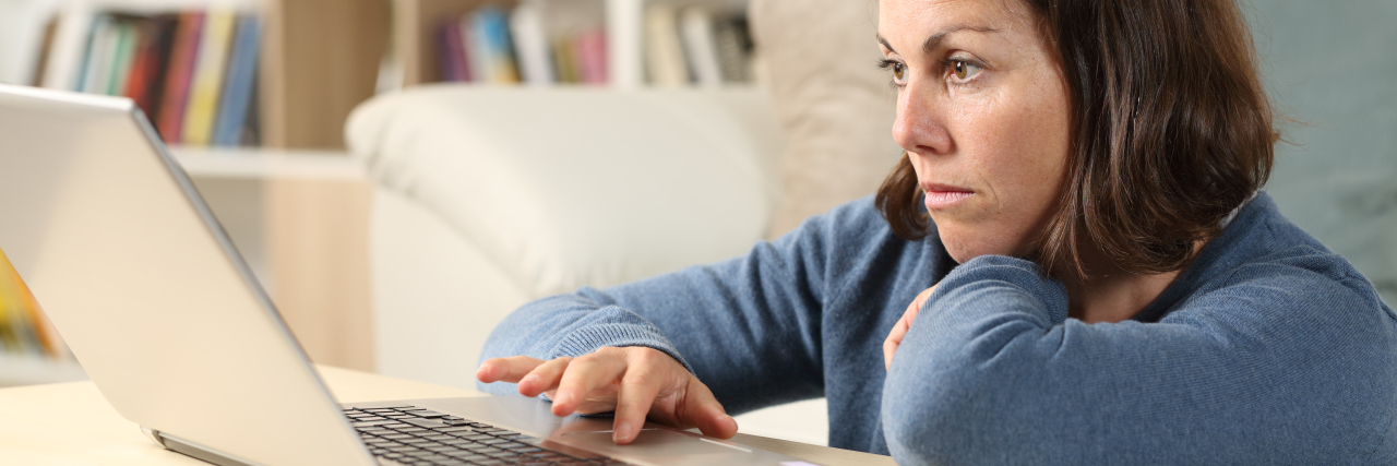 Advocating for Removing the R-Word From Healthcare Forms Serious woman using laptop.