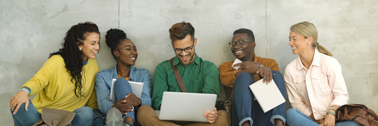 Diverse university students smiling and laughing.