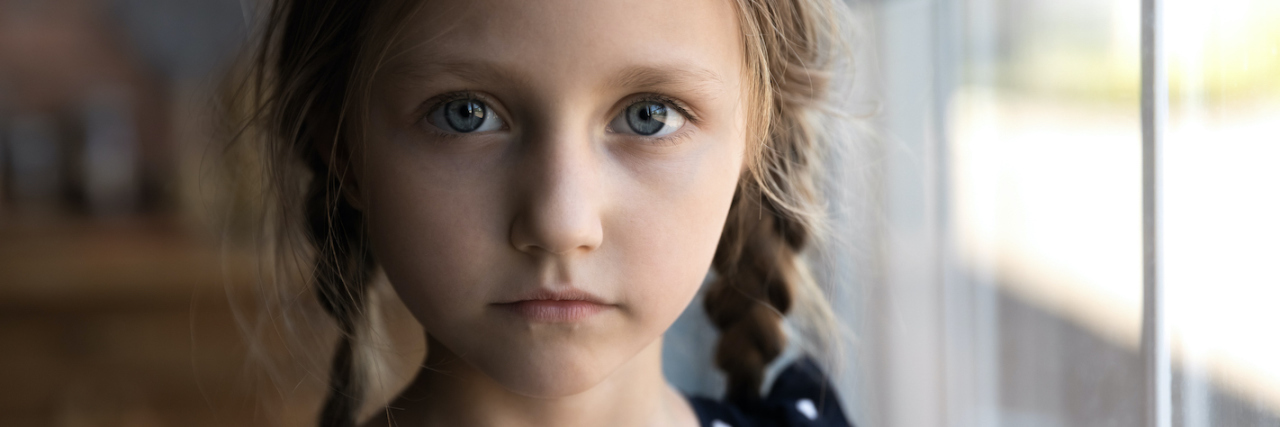How COVID Created a Perfect Storm for Child Grooming A small girl with an unhappy face and blonde pig tails
