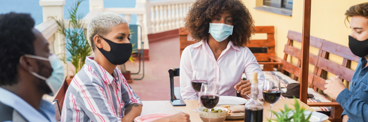 KHN: So You’re Vaccinated Against Covid. Now What? Group of people eating together