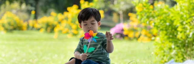 Boy playing with pinwheel.