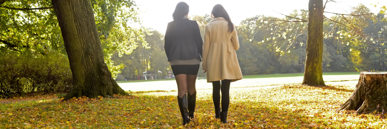 Chronic Illness, Survivor's Guilt and a Friend Meeting Me Where I Was 2 young women walking side-by-side through a field in the fall