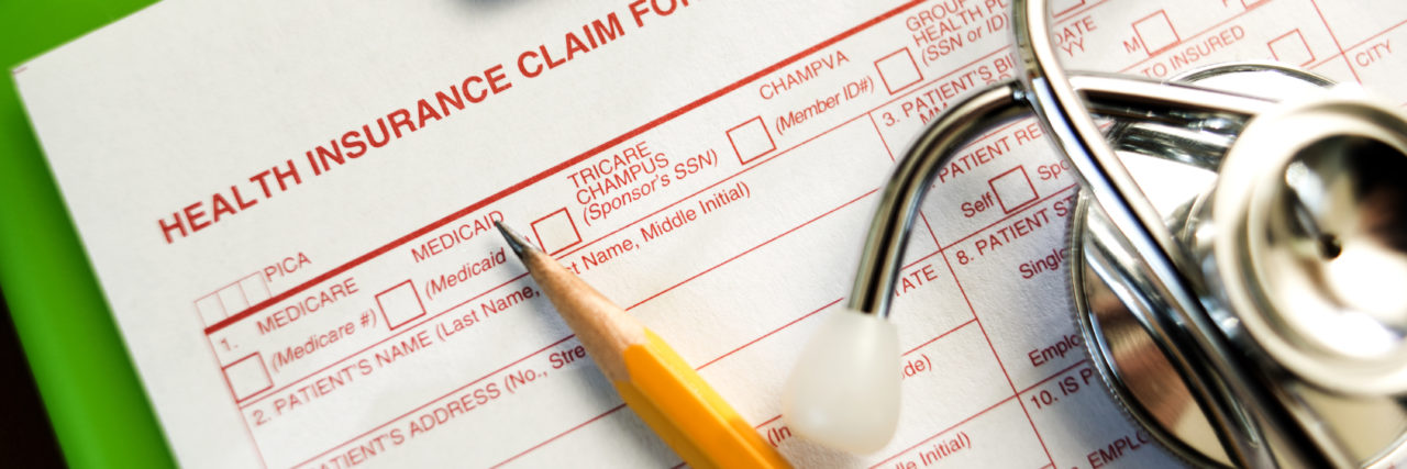 Blank health insurance claim form with pencil
