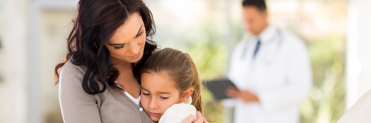How to Talk to Your Child About Your Chronic Illness Child comforting her sick mother at the doctor.