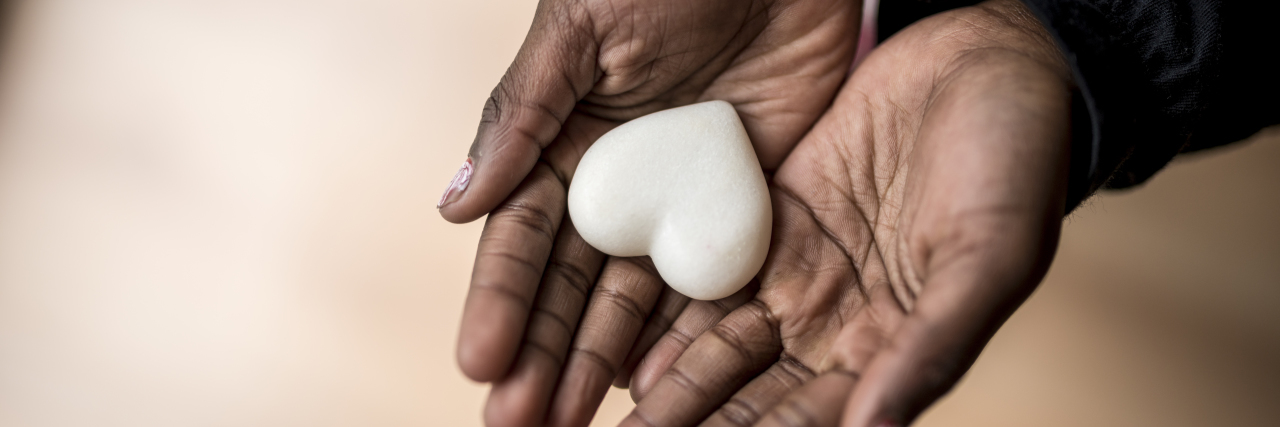 Why Heart Disease is Ignored in the Black Community Two black hands holding a heart