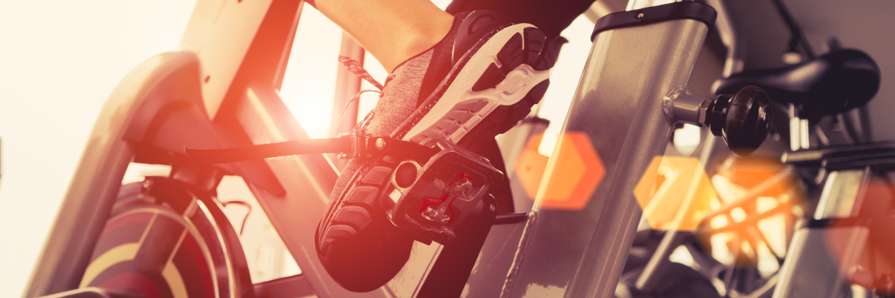 Why Spreading Disability 'Inspiration Porn' Is a Problem Woman riding an exercise bike.