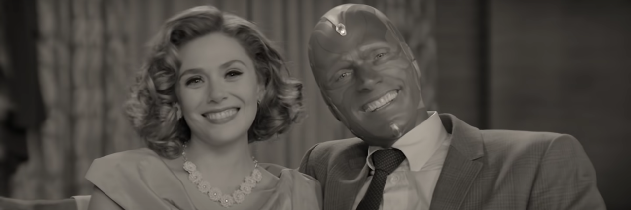 screenshot from Disney and Marvel's WandaVision, showing Wanda and Vision posing and smiling for the camera in 1950s sitcom style