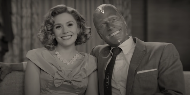 screenshot from Disney and Marvel's WandaVision, showing Wanda and Vision posing and smiling for the camera in 1950s sitcom style