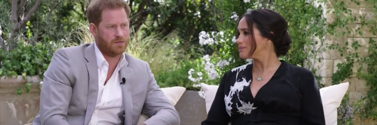 Queen's Statement on Racism Is an Example of 'Polite Gaslighting' screenshot from Prince Harry and Meghan Markle's interview with Oprah Winfrey, showing the couple sitting beside each other, Meghan looking at Harry