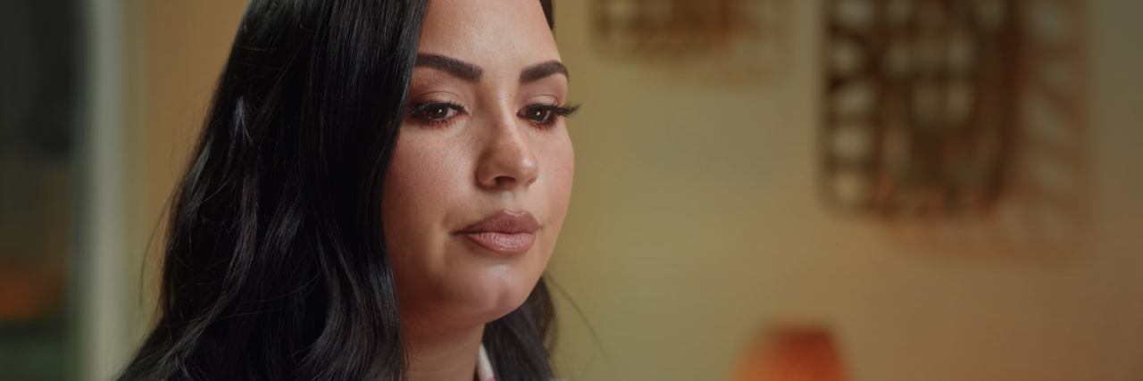 screenshot from Demi Lovato's docuseries "Dancing With The Devil" episode 3, "Reclaiming Power," when she is talking about trauma
