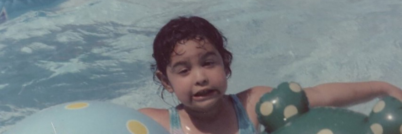 Shayna playing in the pool as a child.