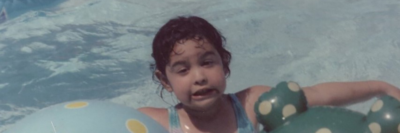 What It's Like Being a Neurodiverse Family in a Neurotypical World Shayna playing in the pool as a child.