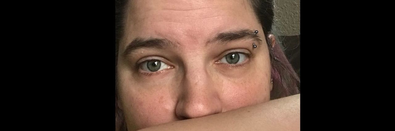 When You're a Depressed Christian a woman with an eyebrow piercing resting her chin on her forearm