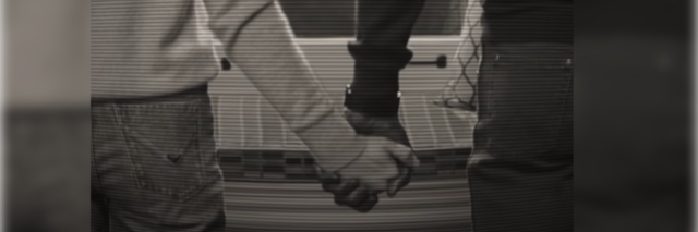 Screenshot from WandaVision where Vision and Wanda hold hands