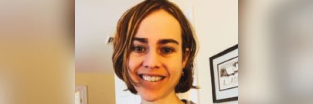 How a Dream Changed My Relationship With My Body and Chronic Illness Selfie of author, a young white woman with brown hair, smiling with a backpack on